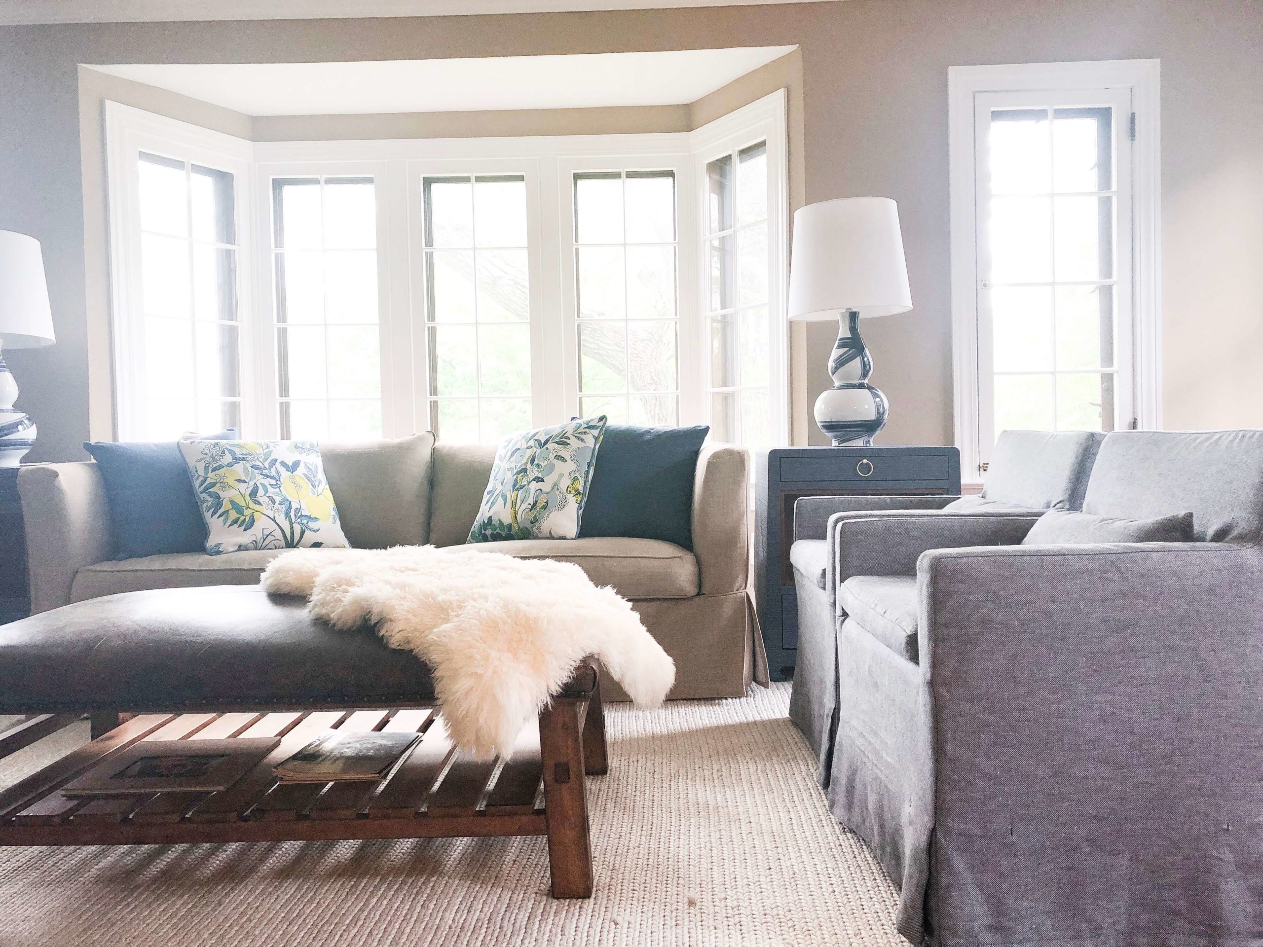 After Photo of Family/Living Room Space adding two blue end tables, matching table lamps, and some new custom pillows Lindsey Putzier Design Studio