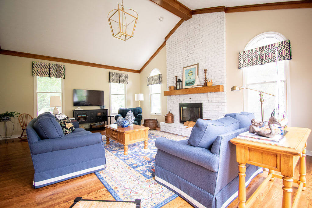 yellow and orange oak flooring and trim, yellow beige walls, and a rug with neutral tones Lindsey Putzier Design Studio 