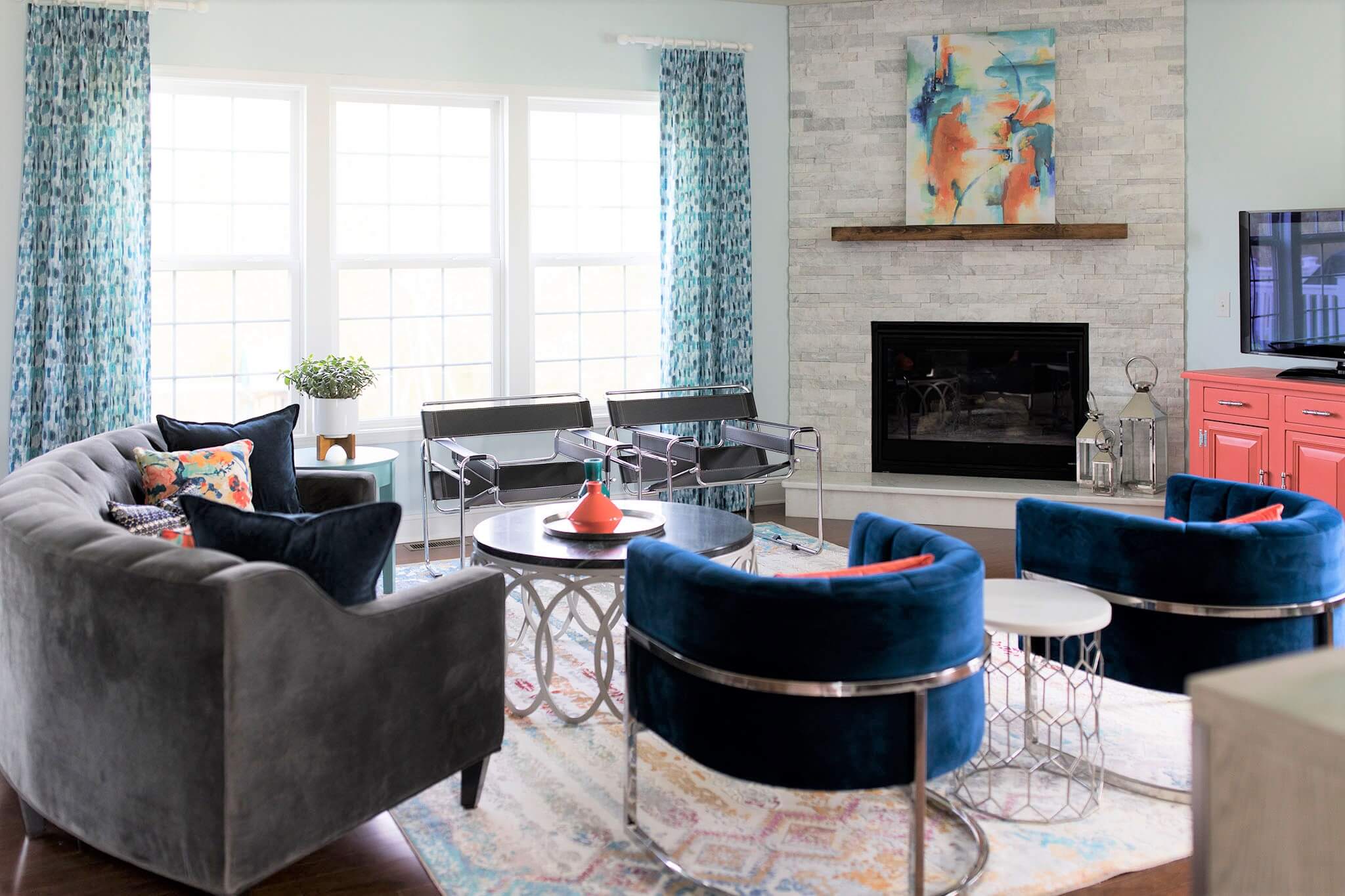 Family Room after sofa, two black and chrome chairs, stone pieces used to create a side and coffee table Lindsey Putzier Design Studio