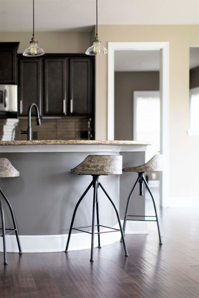 charcoal color with yellow beige granite counters, green beige walls, and cherry floors. Lindsey Putzier Design Studio