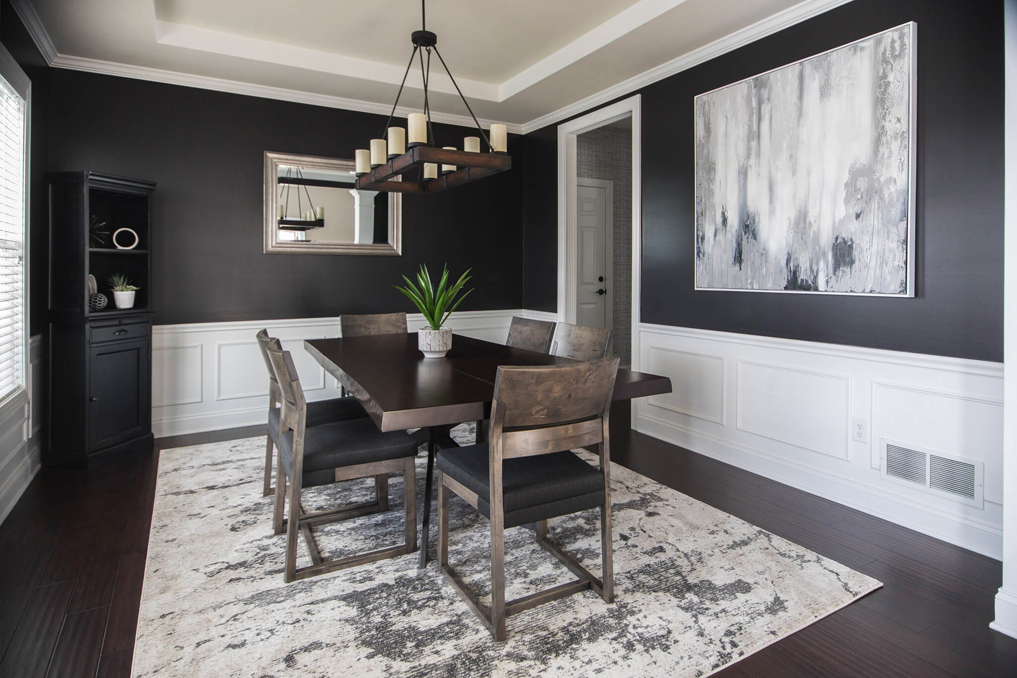 Black walls in Moody Urban Dining Room Space Lindsey Putzier Design Studio