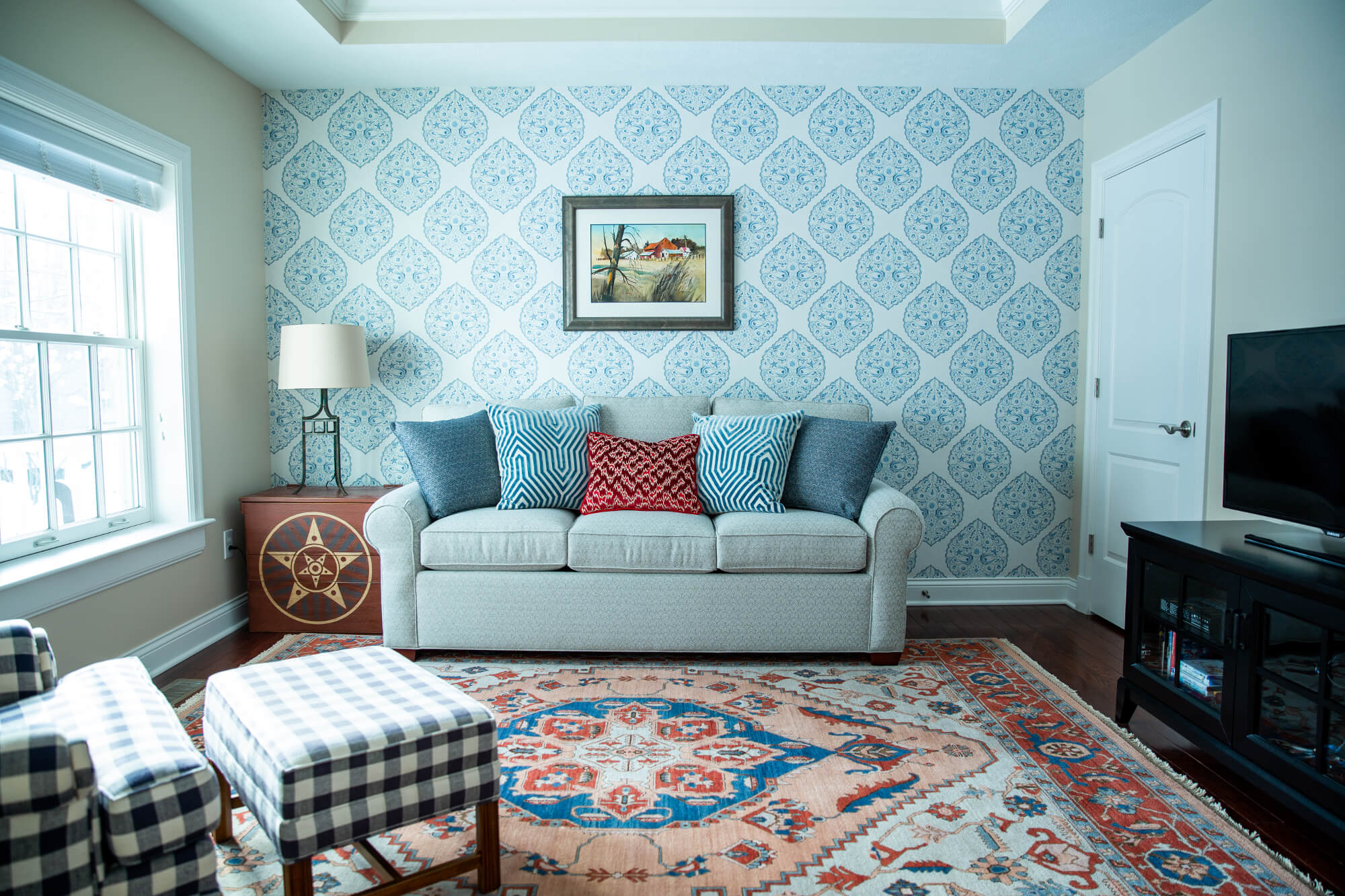 taupe and off-white patterned fabric sofa, pink beige walls, cherry wood flooring Lindsey Putzier Design Studio