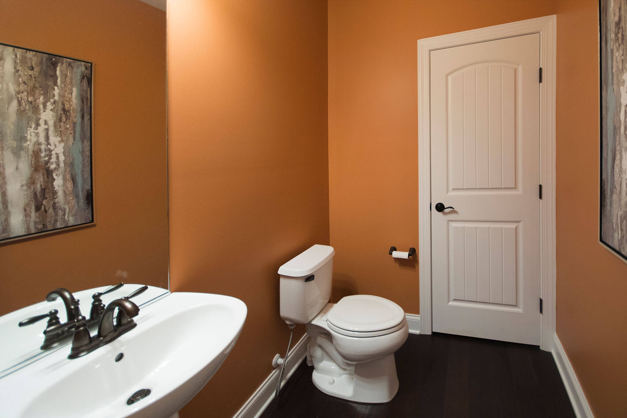 Bathroom Space After with rustier orange colored walls Lindsey Putzier Design Studio