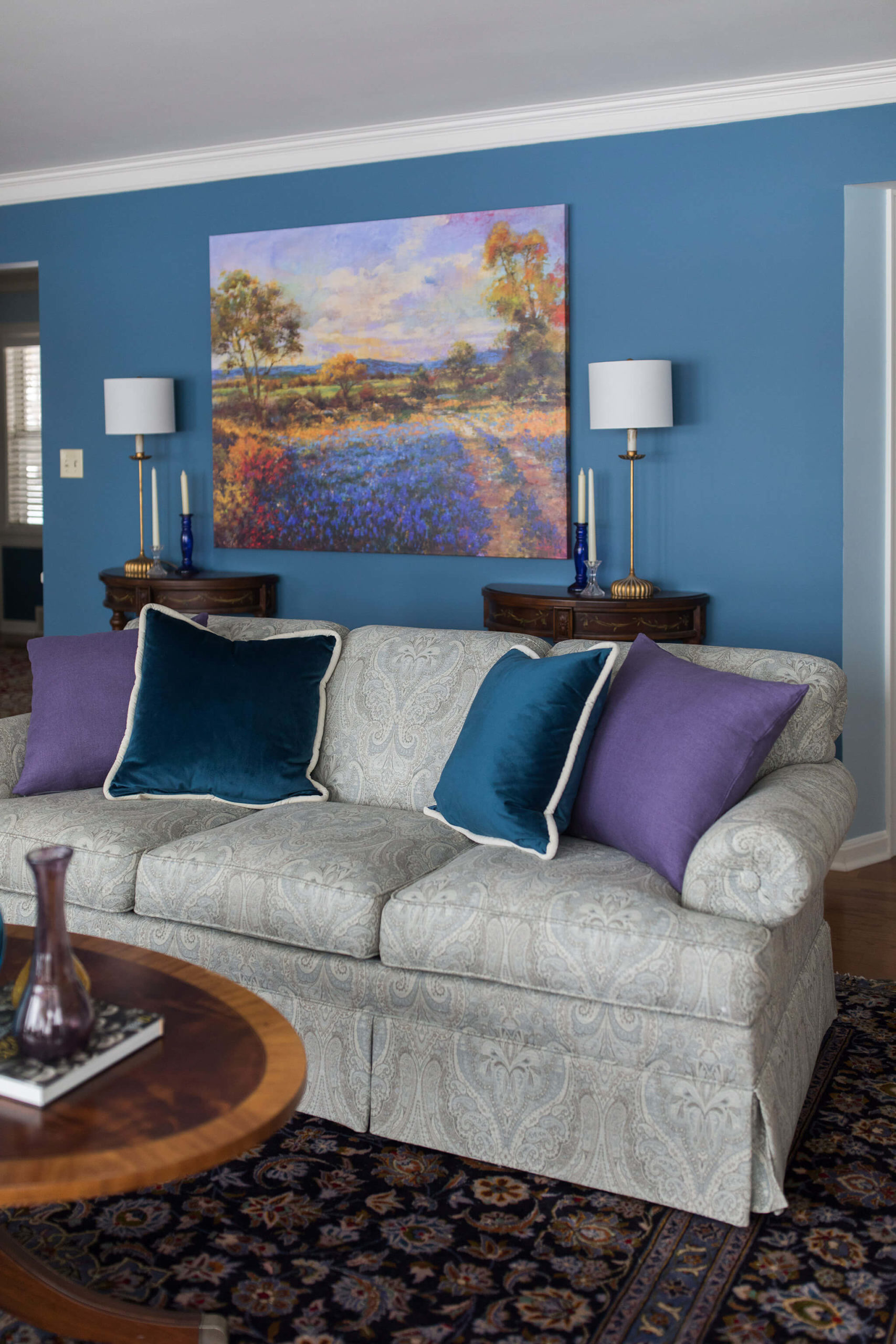 impressionist painting in Family room echoing vintage rug colors Lindsey Putzier Design Studio