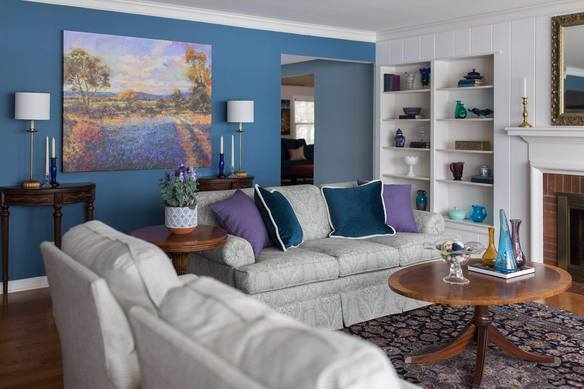 calming medium blue walls in Family Room After new pillows, artwork, rugs, and vintage accessories.