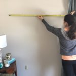Lindsey Putzier measuring wall to hang artwork Eclectic Interiors Ohio