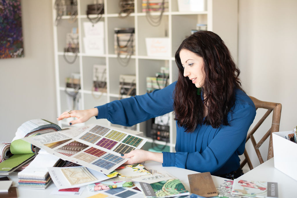 Lindsey Putzier looking through fabric samples Lindsey Putzier Design Studio 