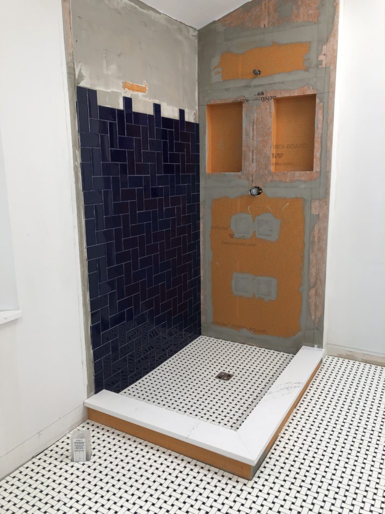 Tranisiton Photo of dark blue herringbone shower tile in Master Bath Eclectic Interiors Hudson Ohio