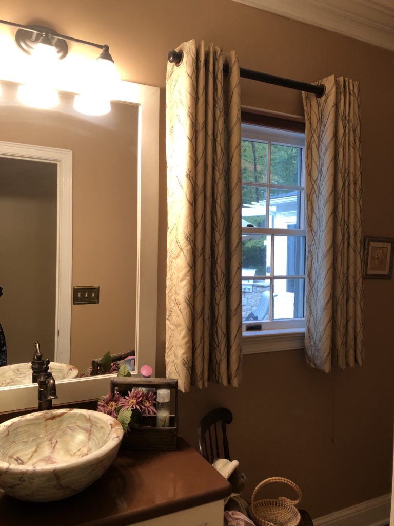 Before photo of Powder Room brown walls, vessel sink, white with tree like patterned draperies Lindsey Putzier Design Studio