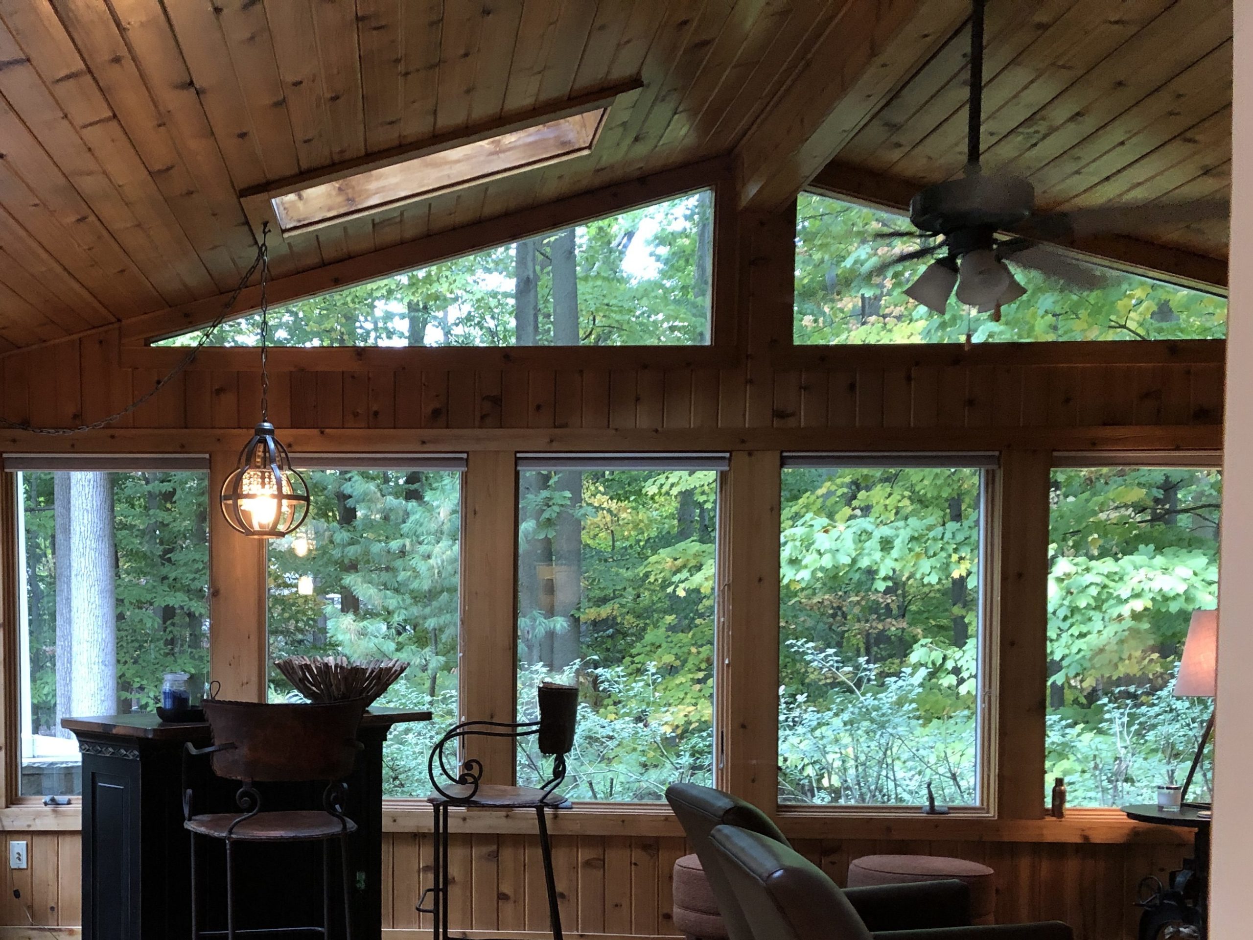 Before photo with ceiling fan, barstools, and wooden walls and ceiling Lindsey Putzier Design Studio