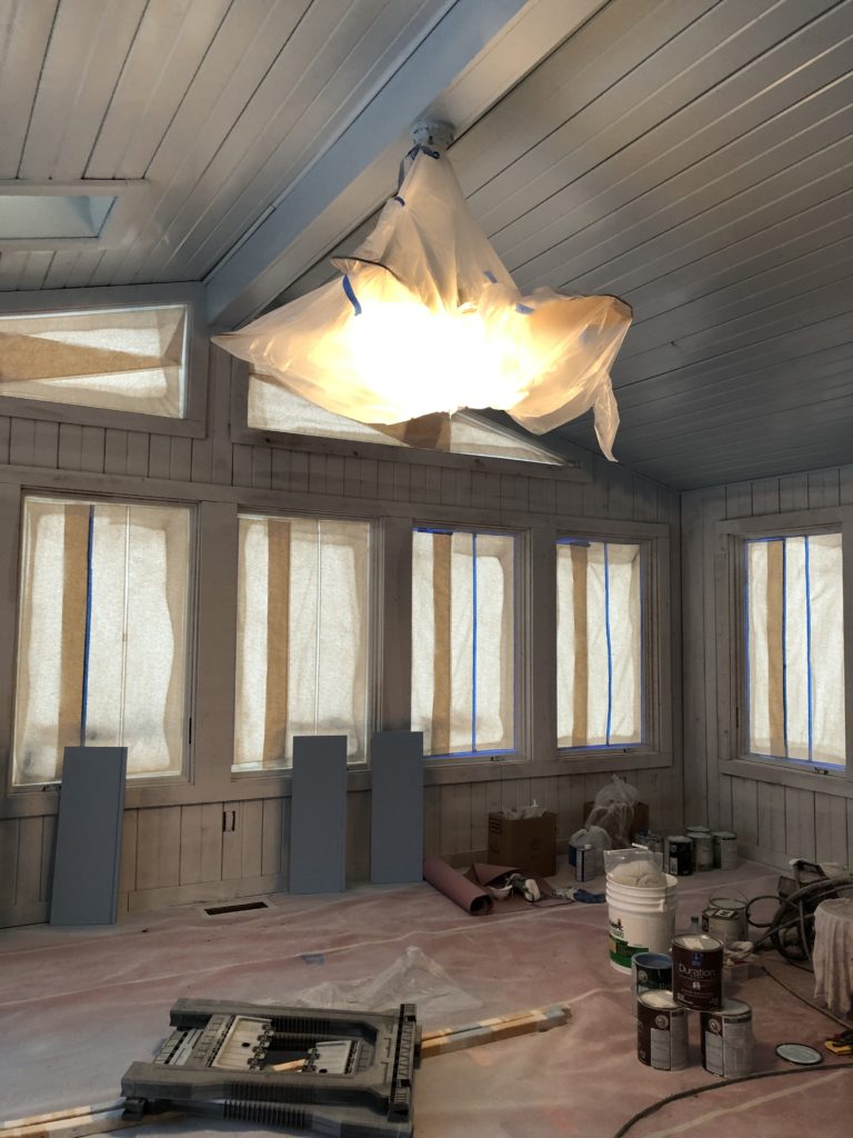Progress photo of wooden walls and ceiling in Sunroom getting painted 