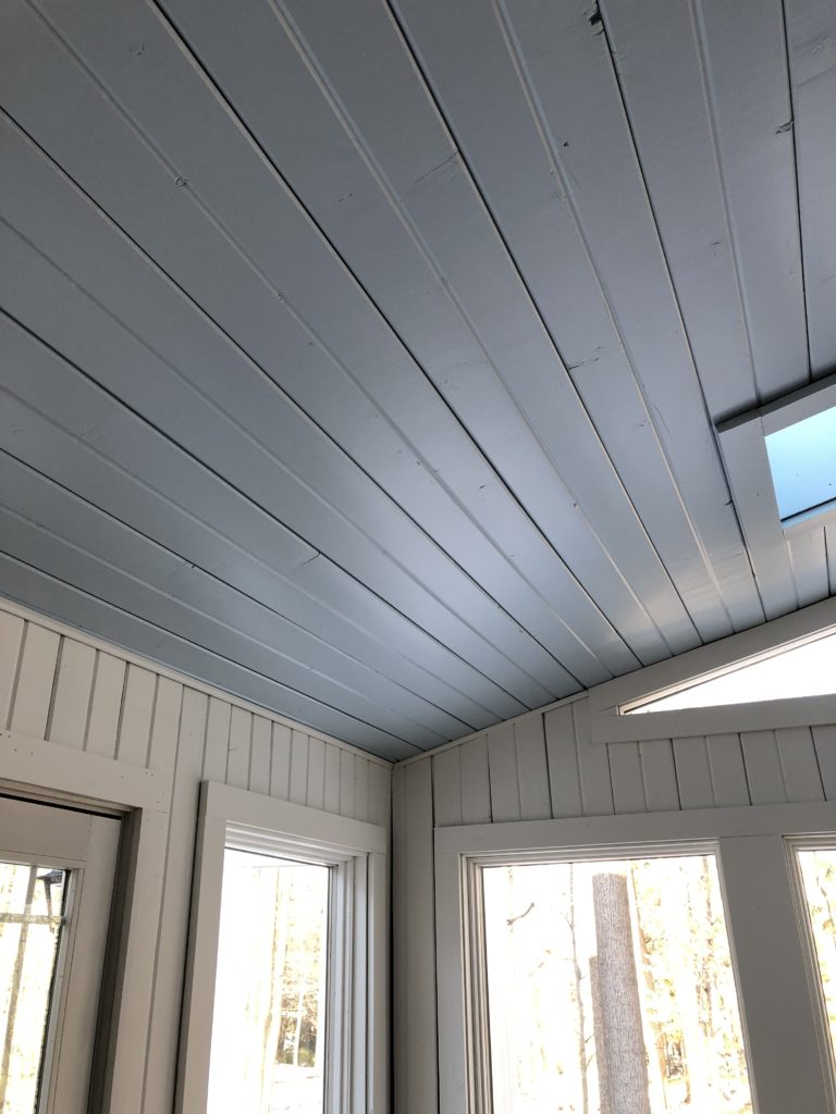 After photo of wooden walls painted white and wooden ceiling painted light blue Lindsey Putzier Design Studio