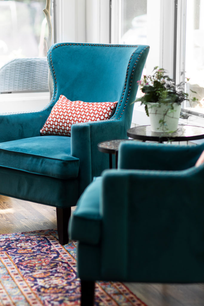 Teal lounge chair with red patterned accent pillow Hudson, OH Lindsey Putzier Design Studio