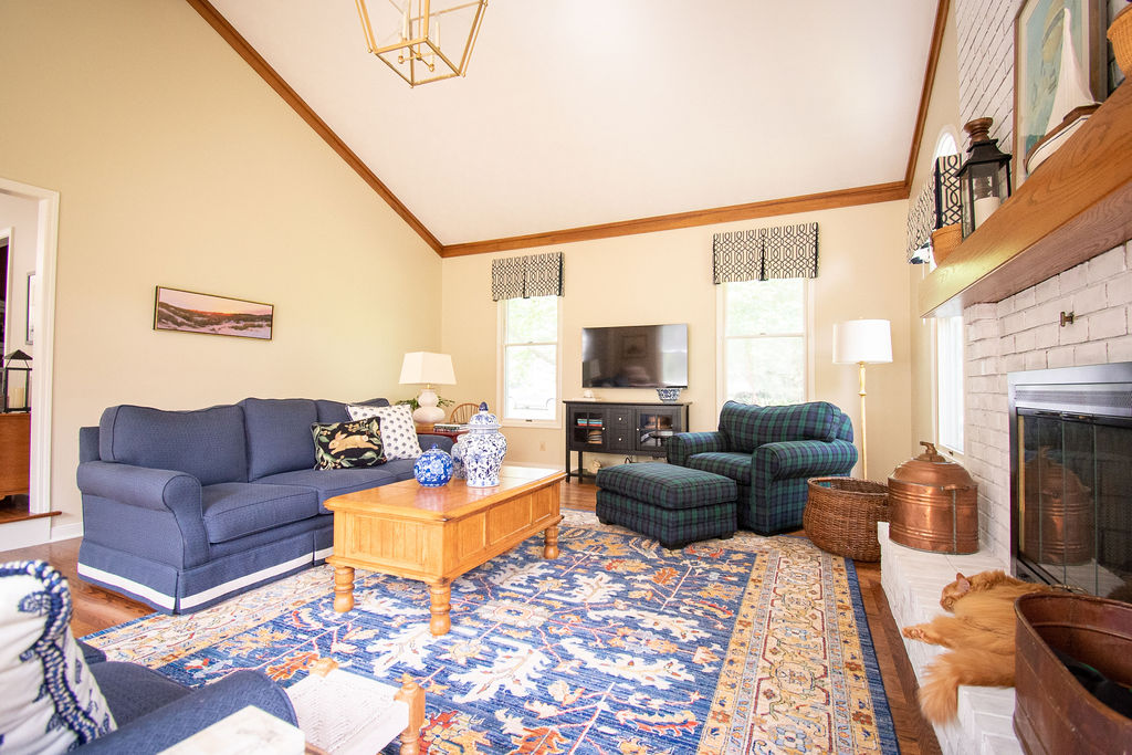 Family Room with custom valances, custom upholstery, and large rug Lindsey Putzier Design Studio