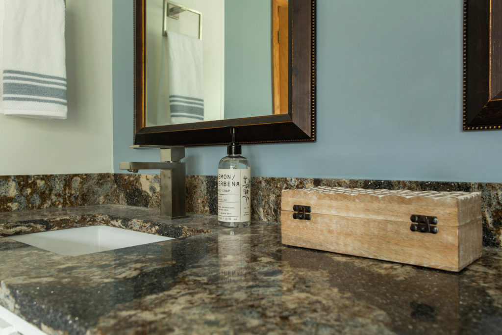 Close up of warm tones in quartz countertops to compare to shower tiles Master Bathroom Lindsey Putzier Design Studio