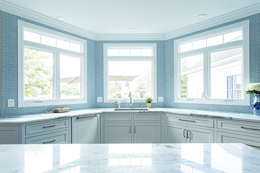 Blue Backsplash tiled kitchen with large, open windows Lindsey Putzier Design Studio