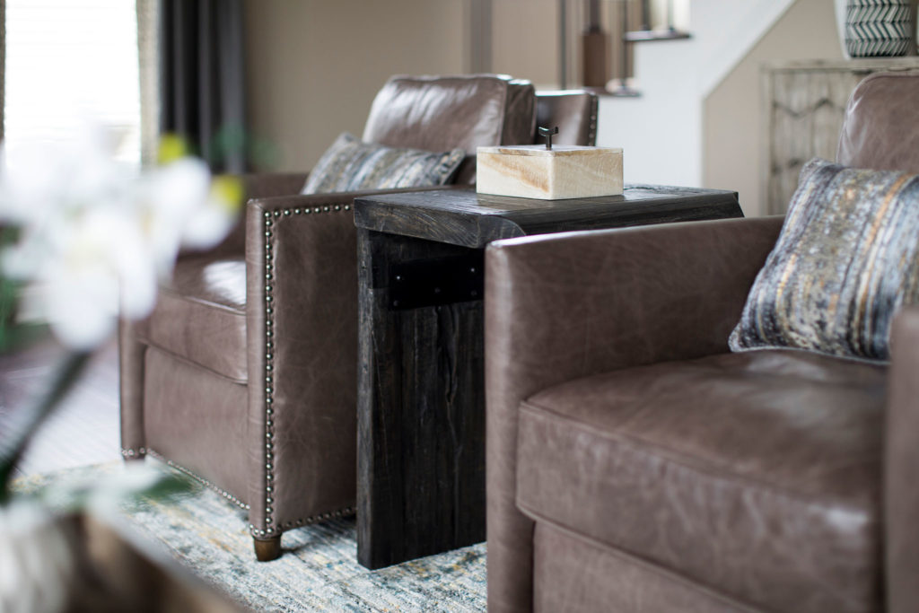 Brown side table between brown leather chairs Lindsey Putzier Design Studio