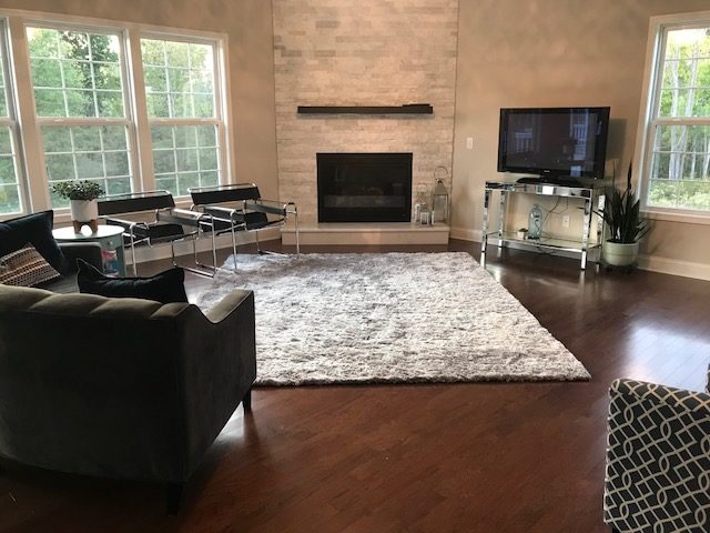 Before image of Living Room with too small of a rug Lindsey Putzier Design Studio