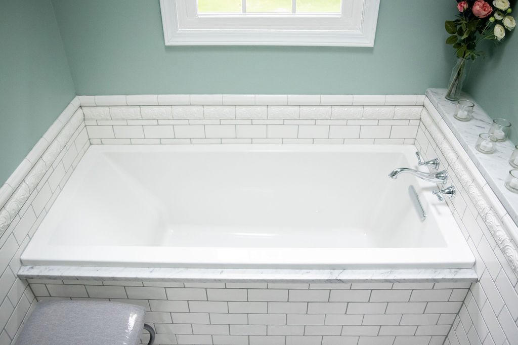 After Bathtub photo with white subway tile surround Before Bath Image for Ohio Bathroom Lindsey Putzier Design Studio