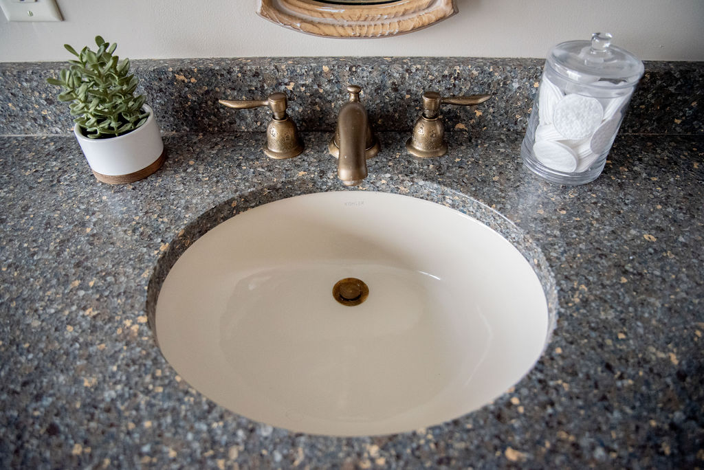 White undermount sink in gray vanity countertop in bathroom Lindsey Putzier Design Studio