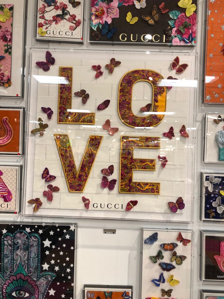 L-O-V-E in gold with pink butterflies encased in Gucci artwork Lindsey Putzier Design Studio