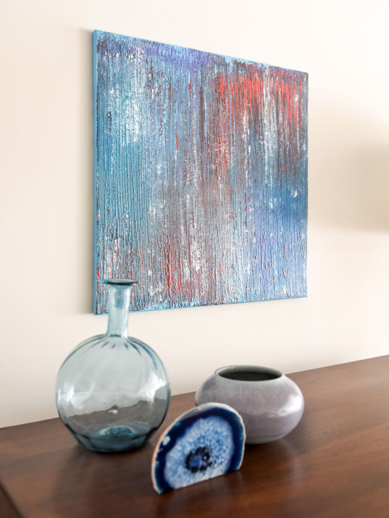 Painting, decorative vases, and blue geode décor