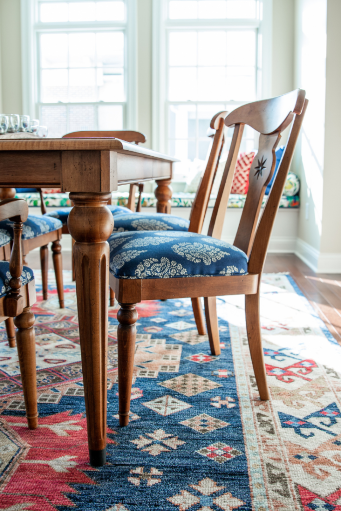 Reupholstered dining chairs with blue cushions  Lindsey Putzier Design Studio