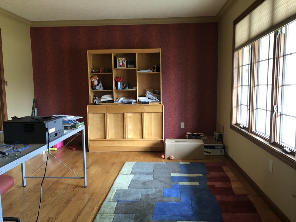 Before Image of Mid-Century sitting room with wooden floors and red wallpapered accent wall Lindsey Putzier Design Studio