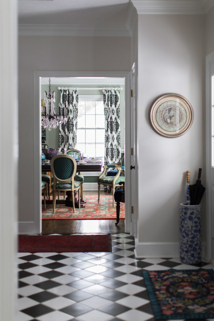 Eclectic Vintage Dining Room shown with foyer tile to match the black and white drapes