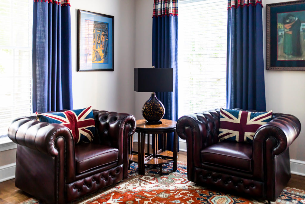 Round side table between two leather, British inspired chairs Lindsey Putzier Design Studio