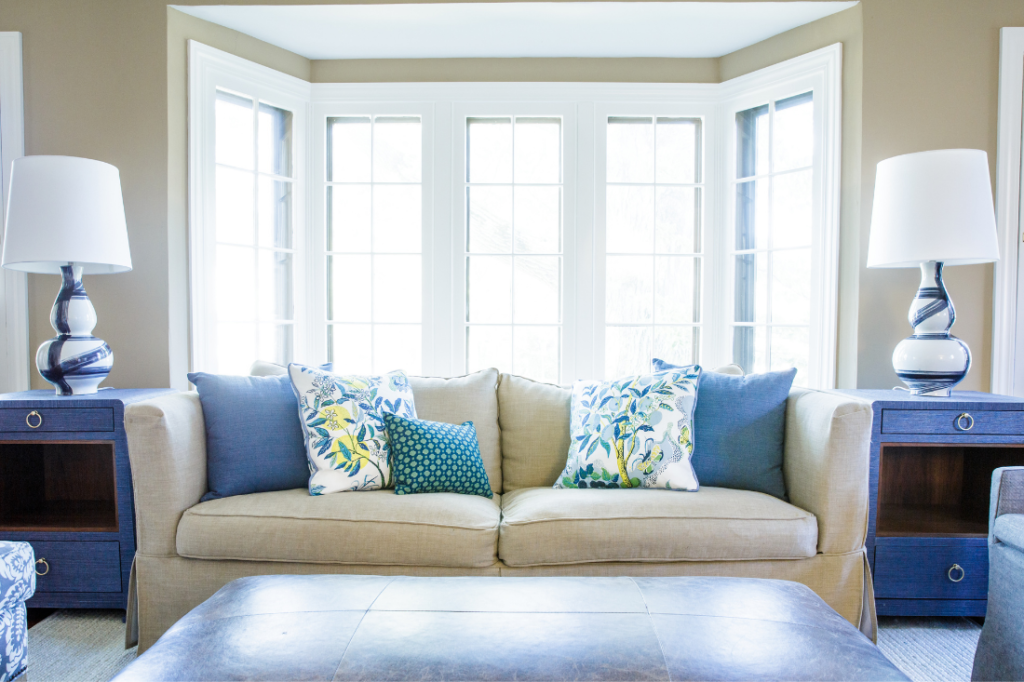Blue end tables on each end of a sofa with custom pillows Lindsey Putzier Design Studio
