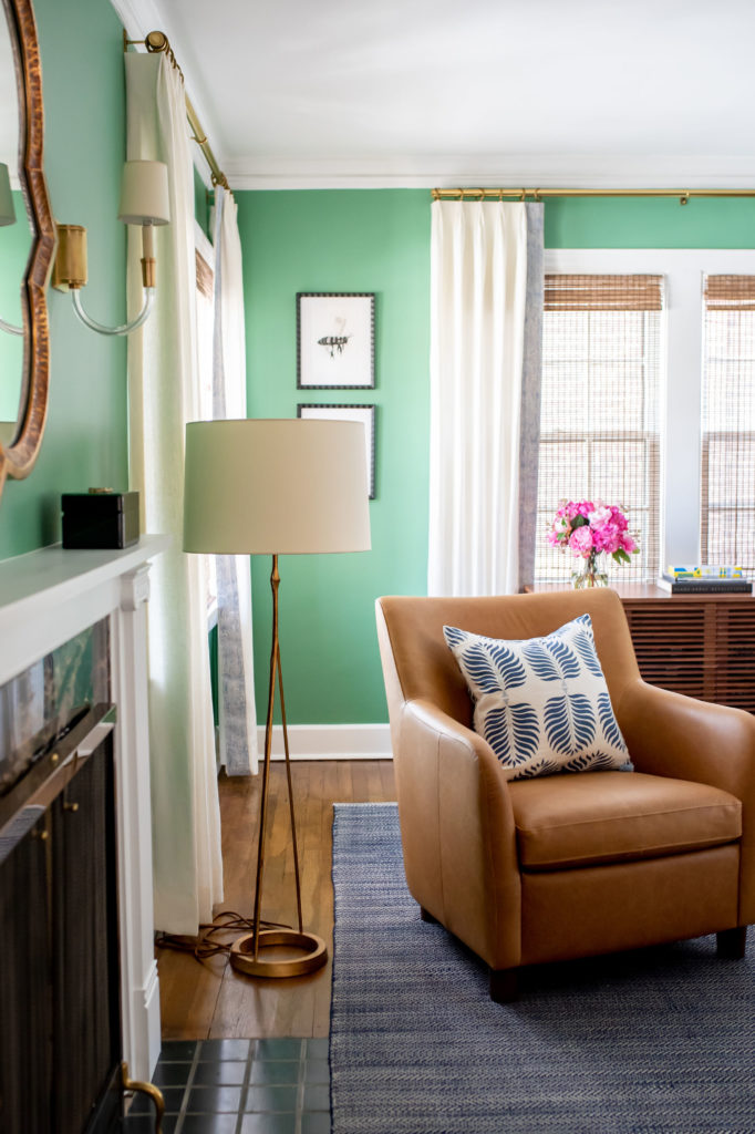 After Living Room Makeover fireplace, floor lamp, and arm chair with custom drapery Lindsey Putzier Design Studio