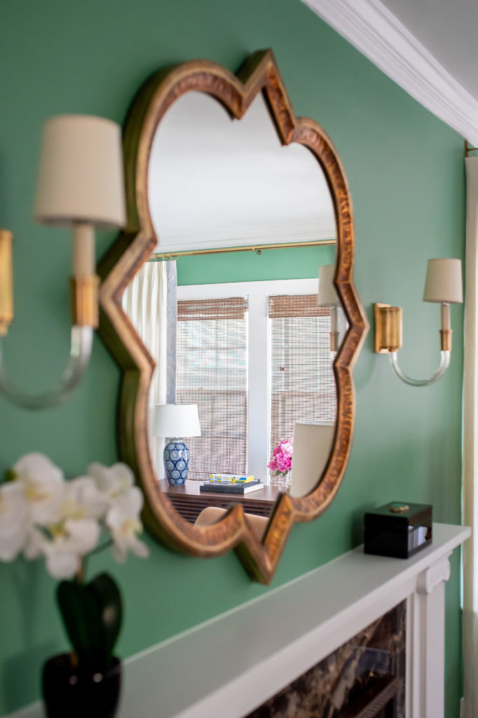 After Living Room Makeover gold mirror, and sconces above fireplace Lindsey Putzier Design Studio