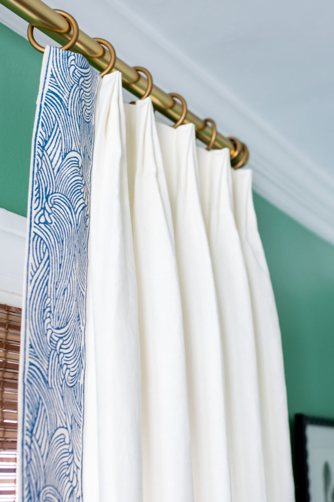 Closeup of pleated custom window treatment in Living Room White fabric with swirly wave/cloud pattern on the trim Lindsey Putzier Design Studio