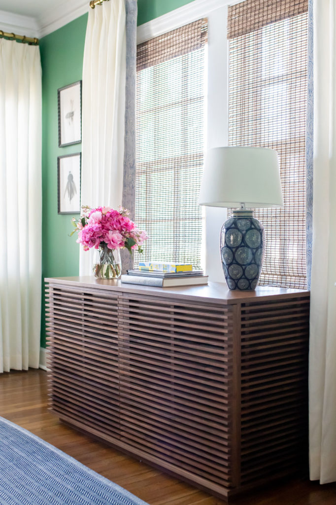 Sideboard in front of shutters and custom window treatments in Living Room Lindsey Putzier Design Studio