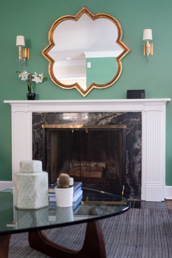 After Living Room Makeover fireplace, gold mirror, sconces, and coffee table Lindsey Putzier Design Studio